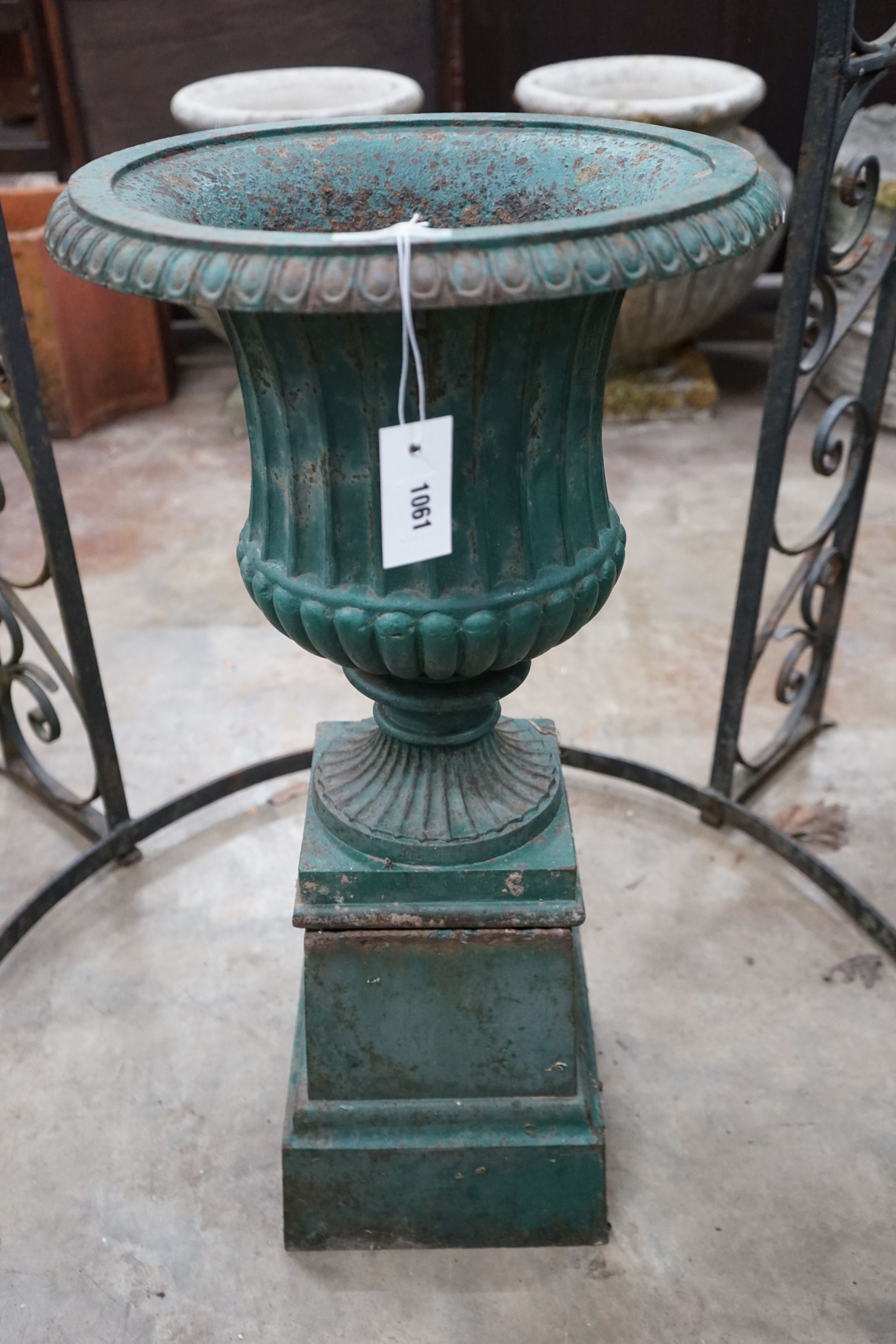 A Victorian painted cast iron campana garden urn on square pedestal stand, diameter 40cm, height 80cm